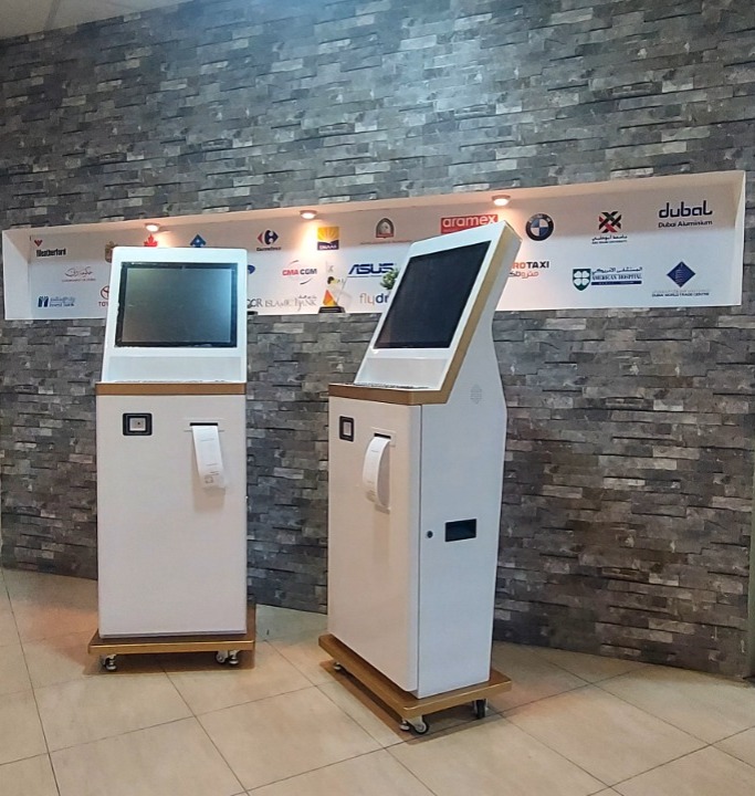 RSI self-service kiosks installed on-site with client branding wall